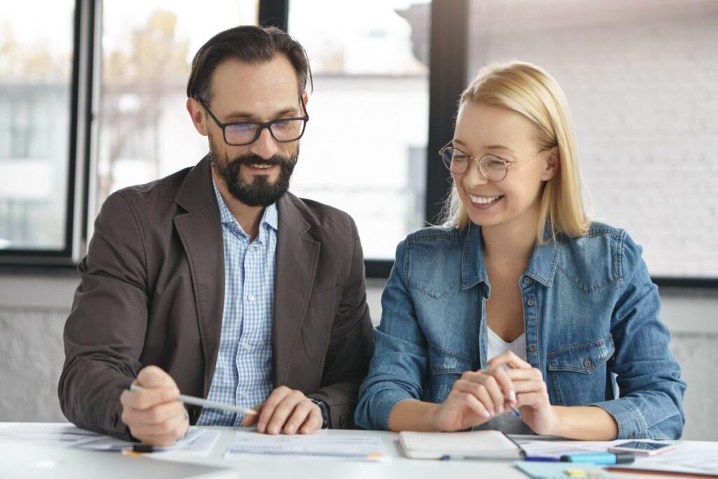 Man and woman working together through financial report.