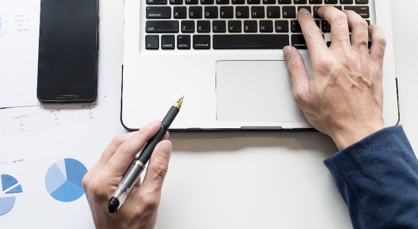 Person working on finances and tax on a laptop.