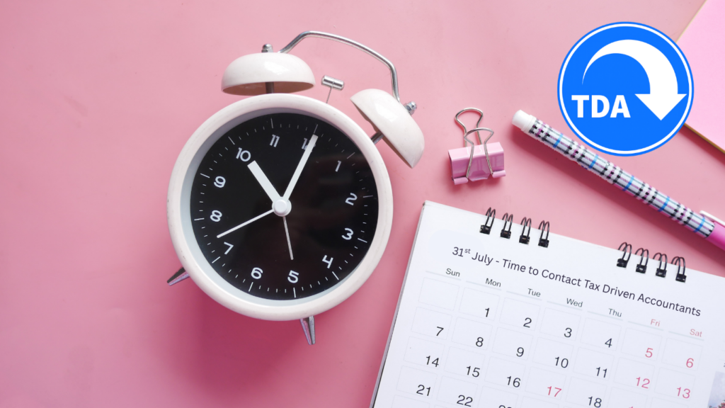 A clock and a calendar on a table with the Tax Driven Accountants logo