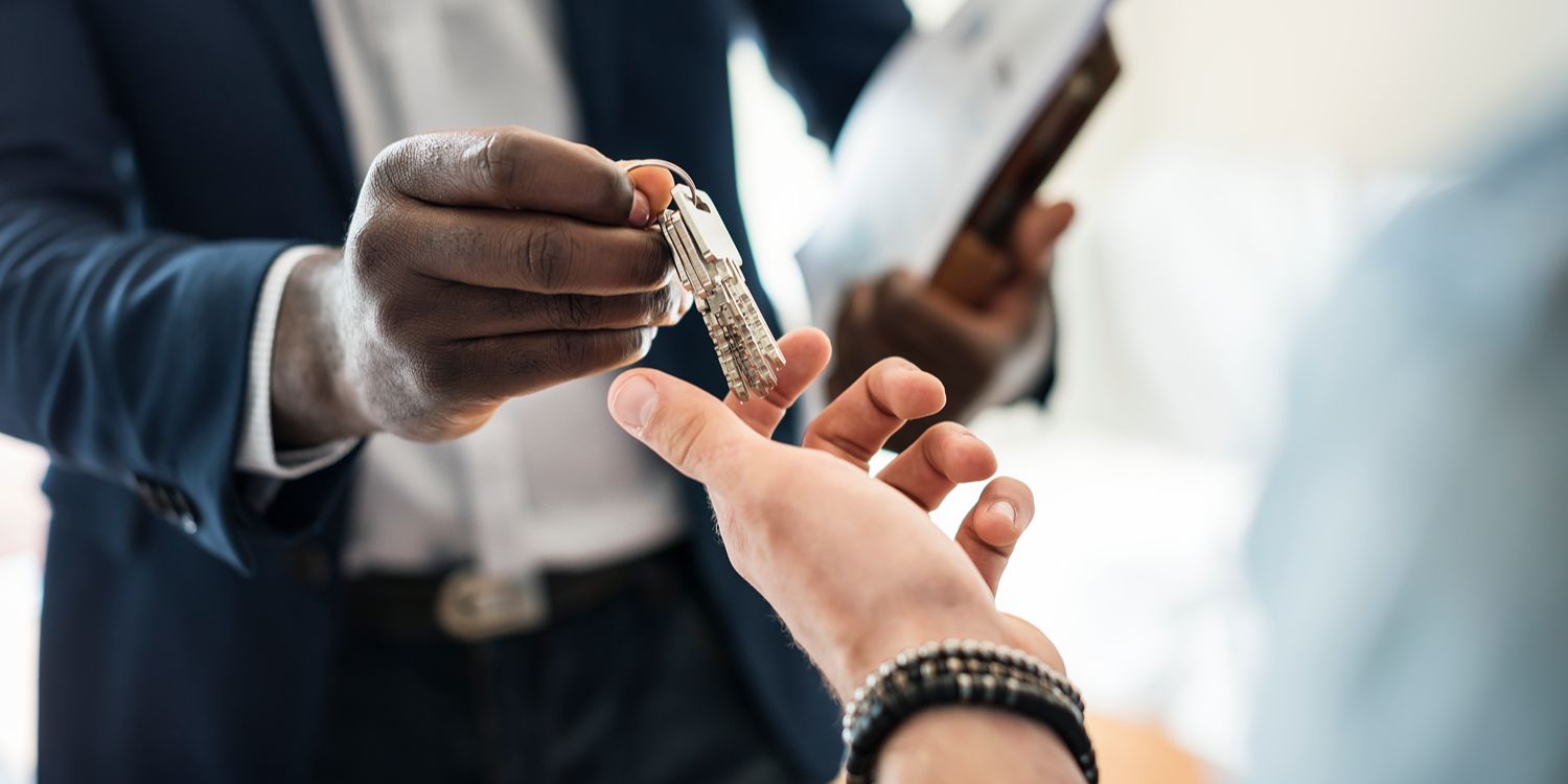 Landlord handing over keys to renter.
